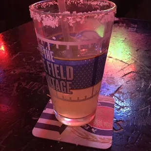 a glass of beer on a coaster