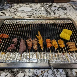 a variety of food on a grill