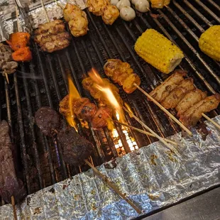 a variety of grilled food on a grill