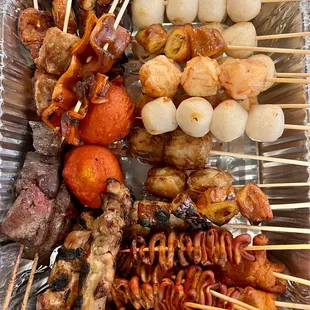 a variety of skewered food