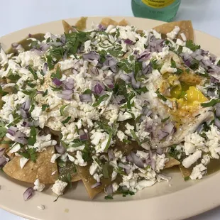 Chilaquiles with Fried Eggs Over Easy and extra Tomatillo salsa