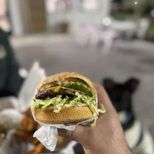 Avocado cheeseburger in an outside area that&apos;s pet friendly