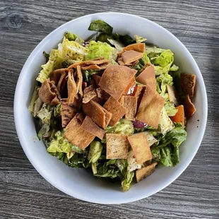 a bowl of salad with croutons