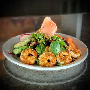 a plate of shrimp and salad