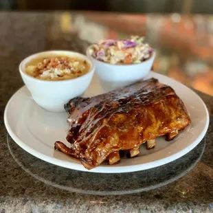 a plate of ribs and coleslaw