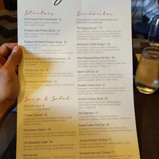 a person holding a menu