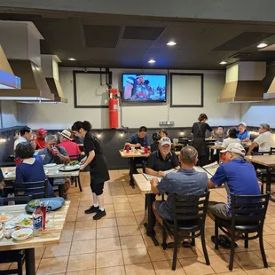 people sitting at tables in a restaurant