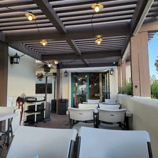 a patio with tables and chairs