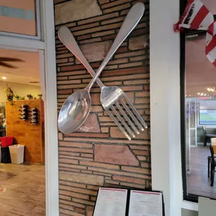utensils hanging on a brick wall