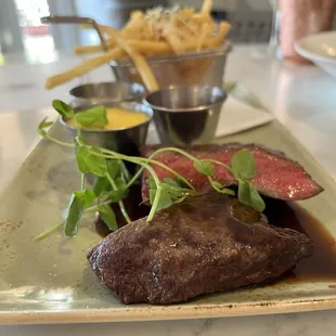 a plate of steak and french fries