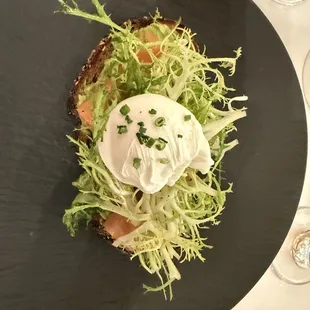 Avocado Toast, topped with salmon and greens.