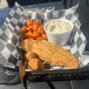 Fried Catfish Plate with sweet potato tots, potato salad and hush puppies.