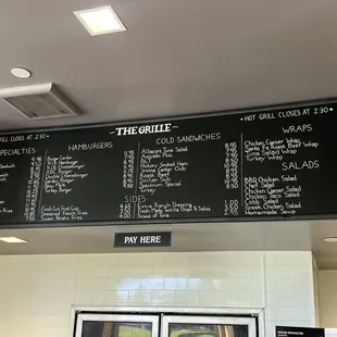 a menu on the wall above the counter