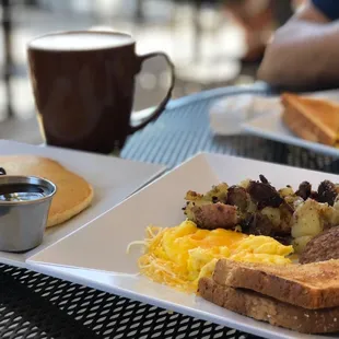 One blueberry pancake, scrambled eggs w/ cheese on top, red potatoes, turkey sausage, toast with large mint chocolate frappe