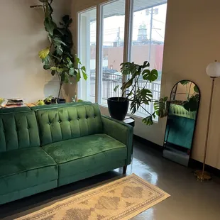 a green couch in a living room