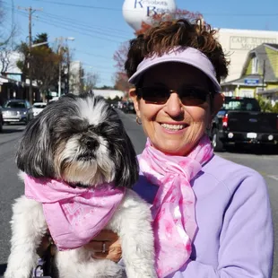 a woman holding a dog