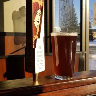 a glass of beer on a bar