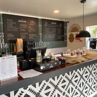 a coffee shop counter with menus on the wall