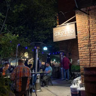 people sitting at tables outside at night