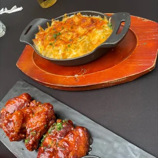 a plate of chicken wings and a bowl of gravy