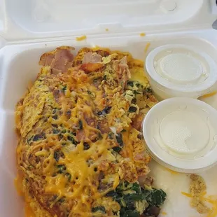 Great omelet.  Made to order, small (3 oz) or large (6 oz).  This is a large with ham, tomatoes, mushrooms, spinach, garlic, and cheese.