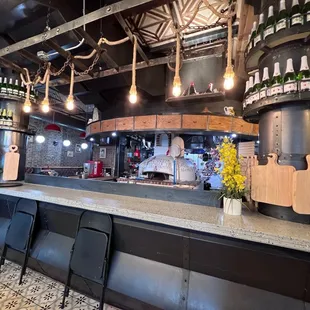 a bar with wine bottles on the counter