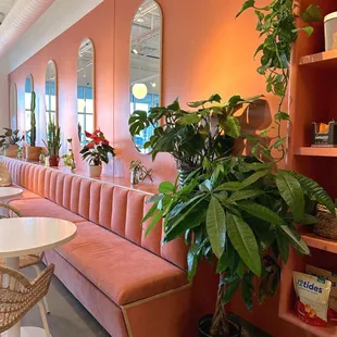 a pink couch and a white table