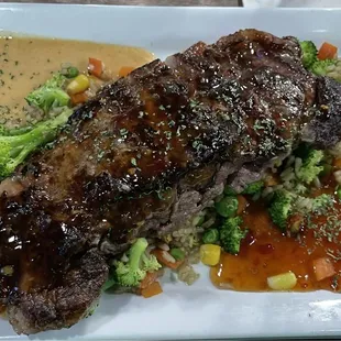 General Tao's Steak with fried rice and steamed vegetables.
