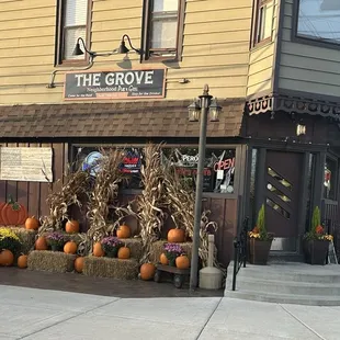 Front door and side display of Fall decor. The outside patio is to the left of pumpkins.