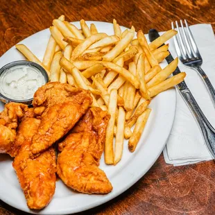 a plate of chicken wings and french fries