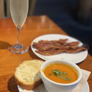 Tomato-basil soup, side of bacon and cava