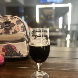 a backpack and a glass of beer
