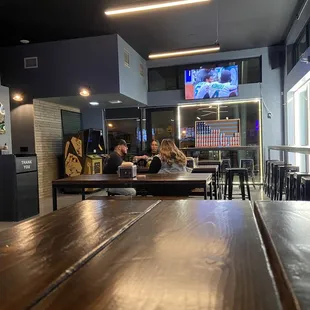 people sitting at tables in a bar
