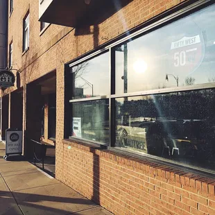 the reflection of the sun in the window