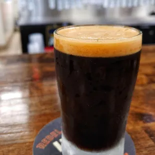 a glass of beer on a coaster