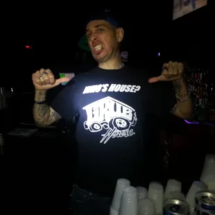 a man in a black t - shirt holding a toothbrush