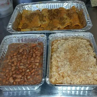 three pans of baked beans and rice