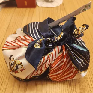 Wrapped set containing a box of sushi, a pack of seaweed, and a can of miso soup