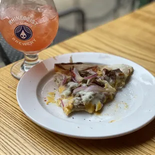 a slice of pizza and a glass of beer