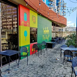 a colorful building with tables and chairs