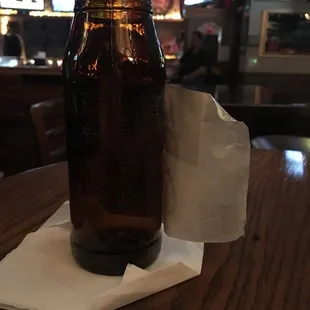 a beer bottle on a napkin