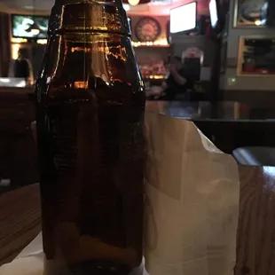 a beer bottle on a napkin