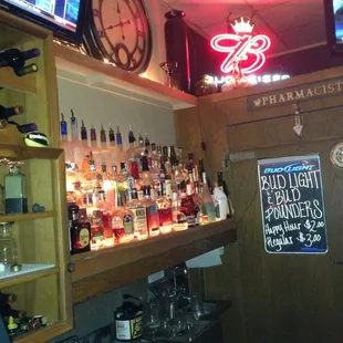 a bar with liquor bottles and a clock