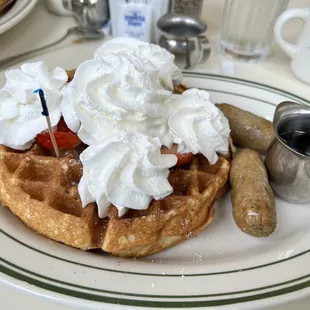 Waffle with strawberries, whipped cream and chicken sausage