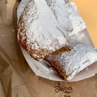 two pieces of powdered sugar pastries