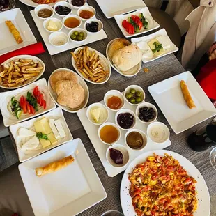 Kurdish breakfast for two: eggs, cheeses, jams, olives, fresh bread, fried cheese rolls.