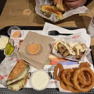 a tray of burgers and onion rings