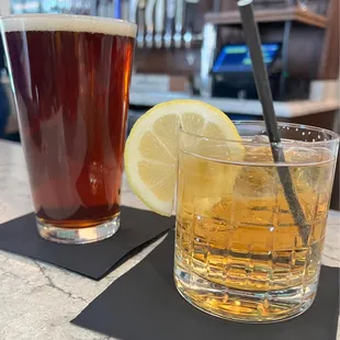 two glasses of beer and a lemon slice