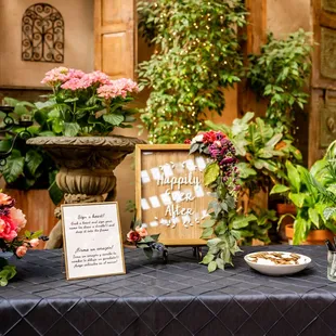 Sign in table. We loved all the plants and twinkle lights! (Jason Burns Photography)