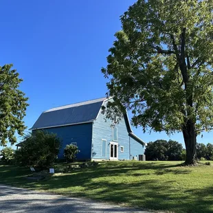 a blue barn in a field